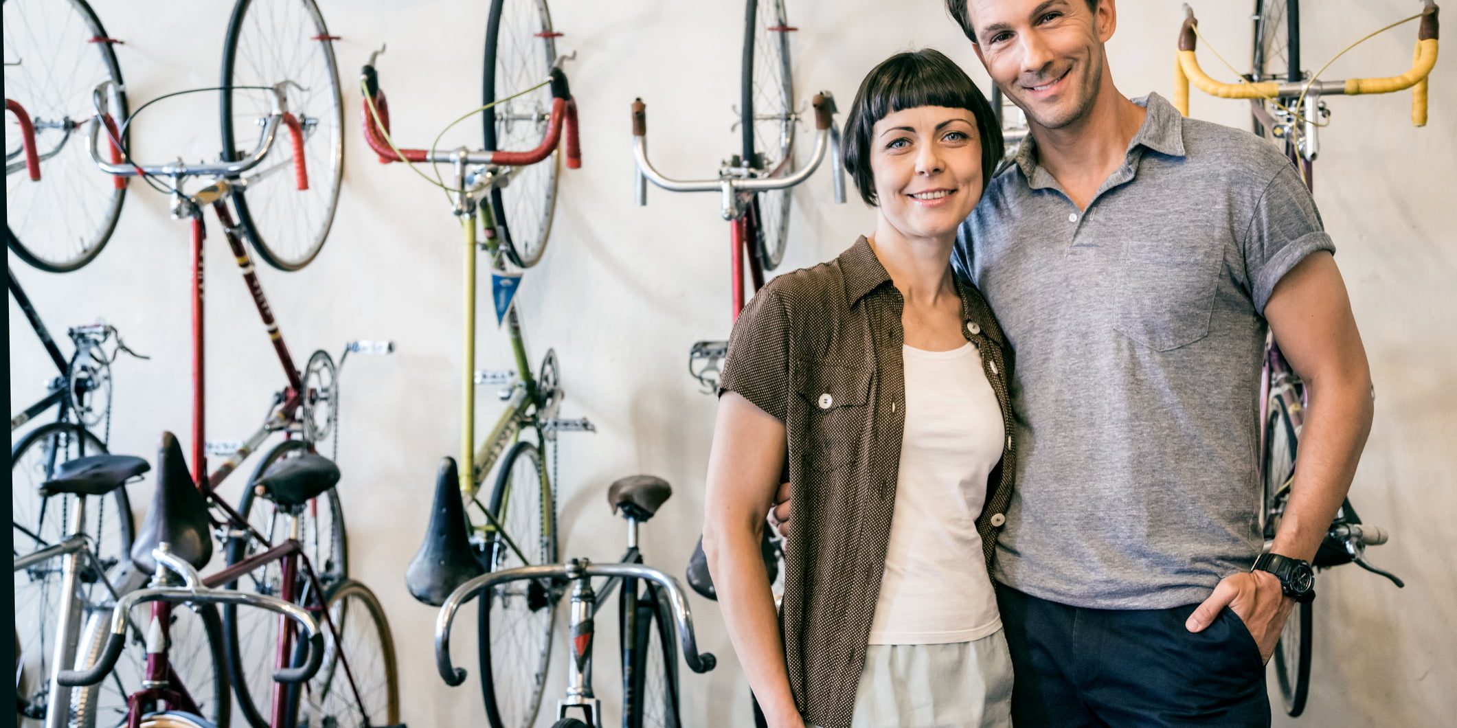 Mature couple and owner of a hip Berlin bike store. Some grain visible.